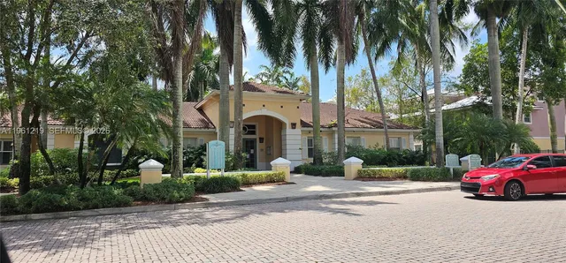 a view of a street with a cars park side of the road