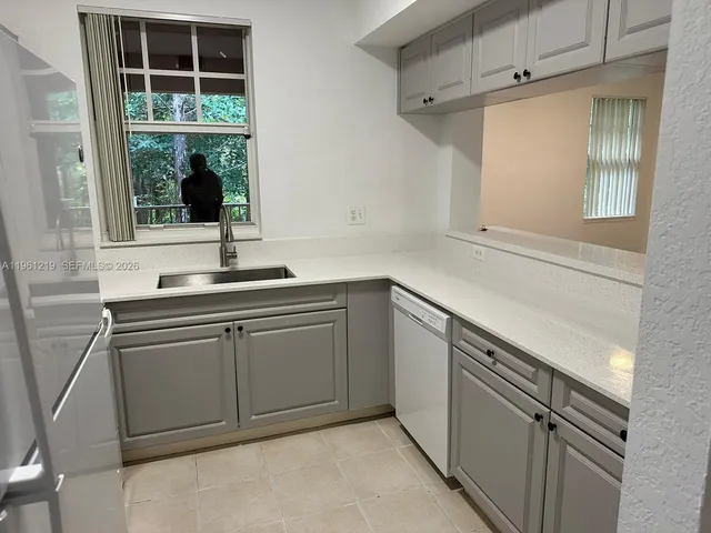 a kitchen with a sink and a window