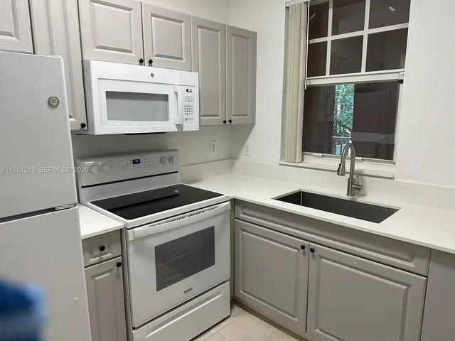 a kitchen with cabinets and window