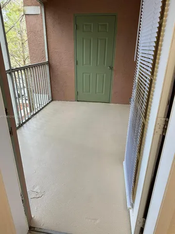 a view of a hallway with wooden floor and stairs