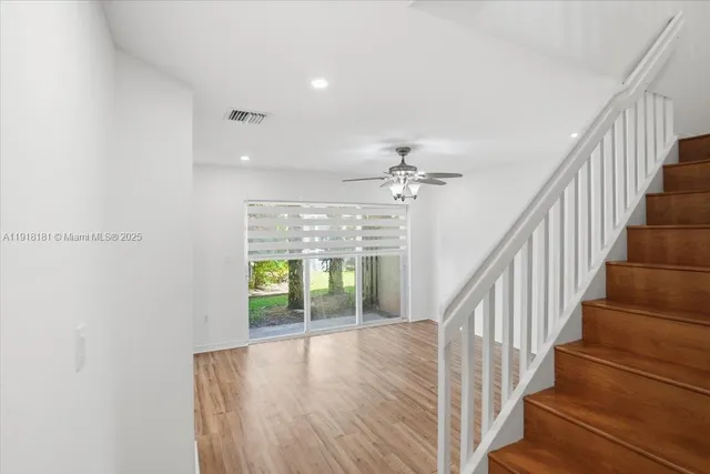 a view of entryway and hall with wooden floor