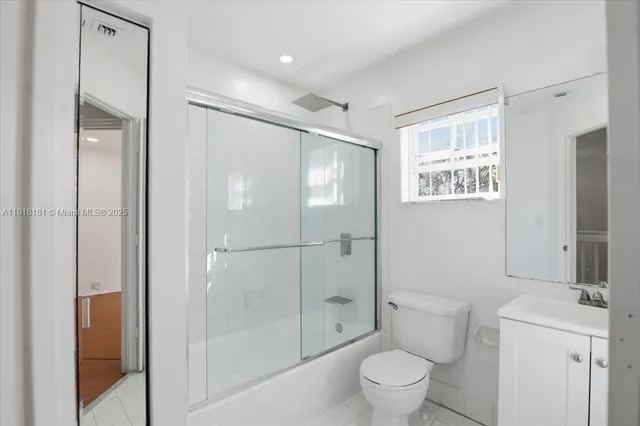 a bathroom with a shower toilet and sink