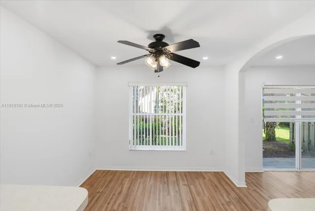 a bedroom with a bed and a chandelier fan