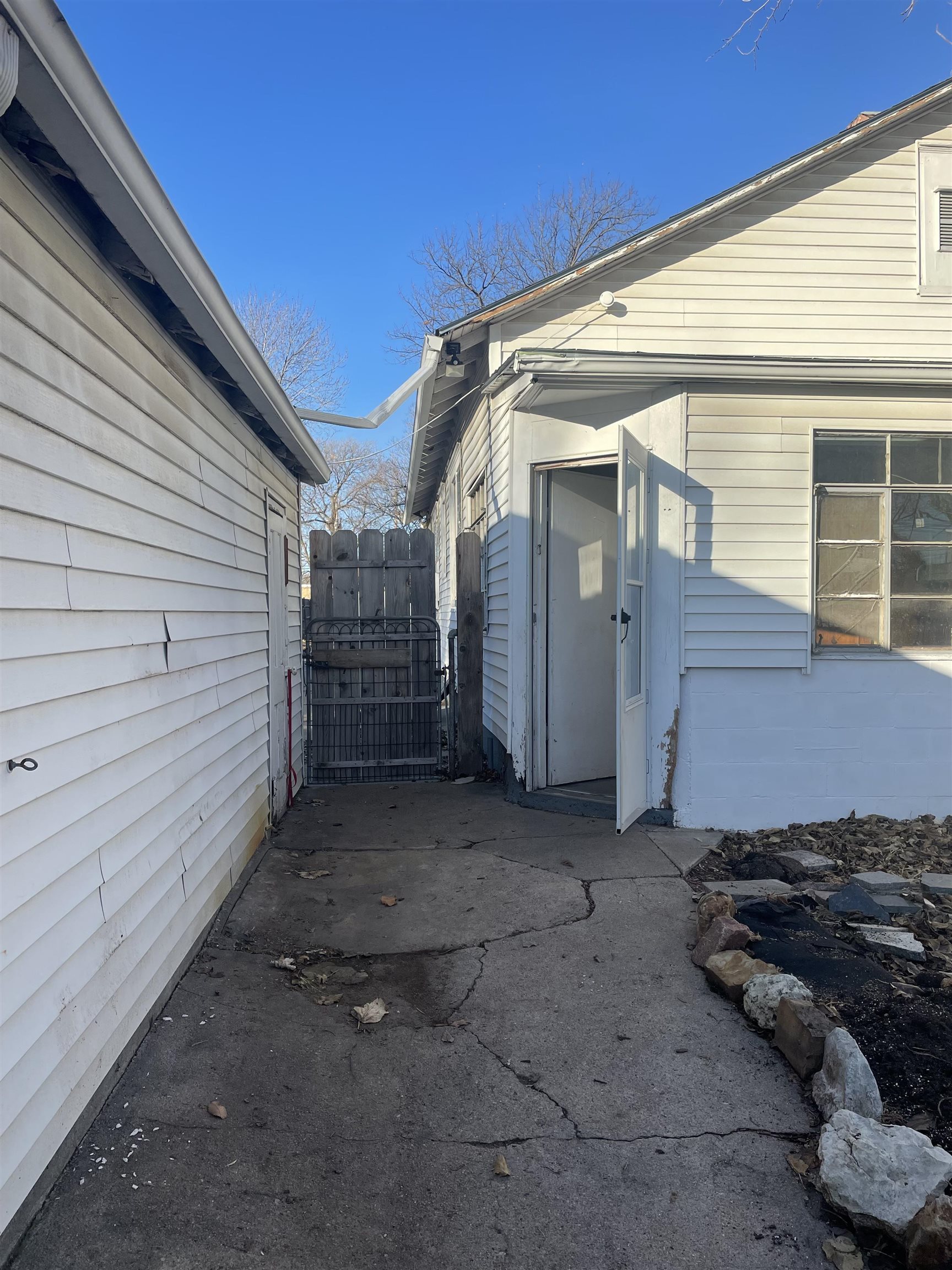 1646 South Topeka Avenue Wichita, KS 67211 - Photo 32 of 36 This is the North side of the garage, looking West to the driveway, entrance to the mud room on the house, and back door area.
