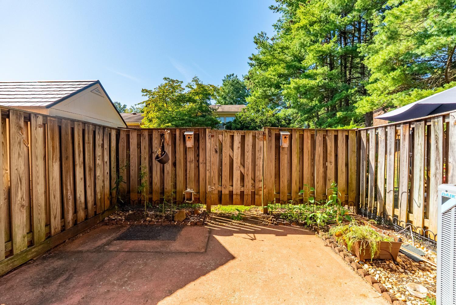 3101 Link Road, Unit 11 Lynchburg, VA 24503 - Photo 30 of 41 a view of a backyard with a barbeque and wooden fence