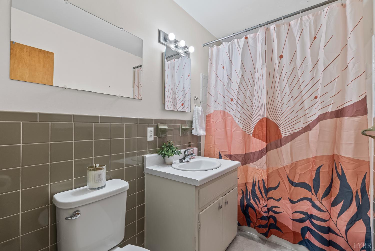 3101 Link Road, Unit 11 Lynchburg, VA 24503 - Photo 5 of 41 a bathroom with a sink a toilet and shower curtain
