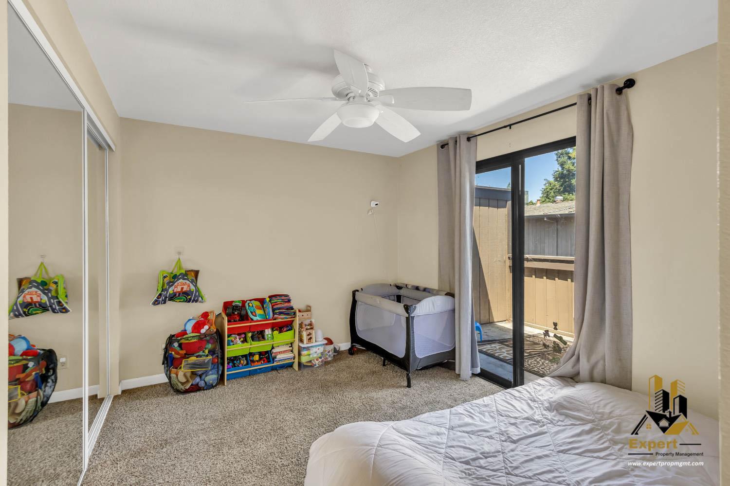 903 Fulton Avenue, Unit 406 Sacramento, CA 95825 - Photo 14 of 23 a bedroom with a bed and a window