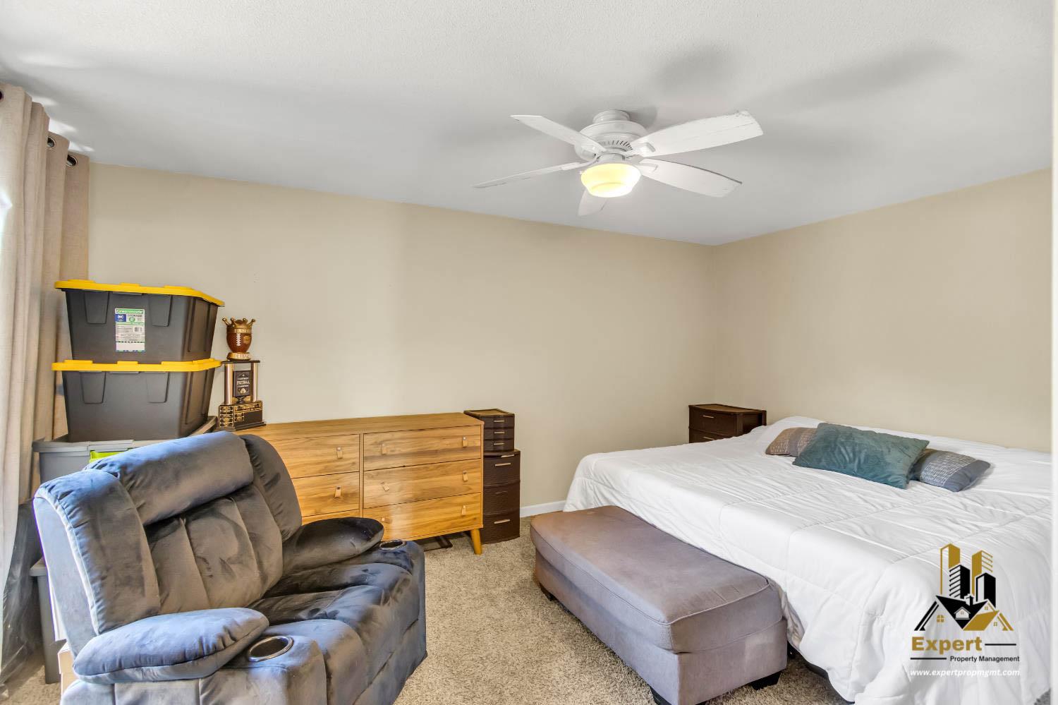 903 Fulton Avenue, Unit 406 Sacramento, CA 95825 - Photo 17 of 23 a bedroom with a bed and furniture