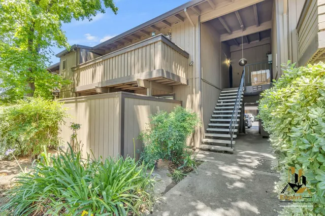 a front view of a house with a yard and a garage