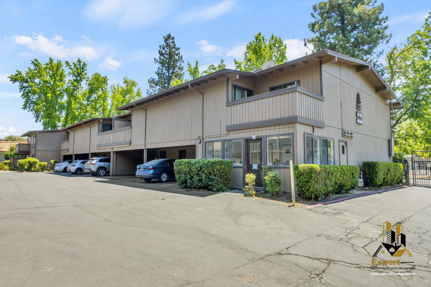 903 Fulton Avenue, Unit 406 Sacramento, CA 95825 - Photo 21 of 23 a front view of a house with a yard and a garage