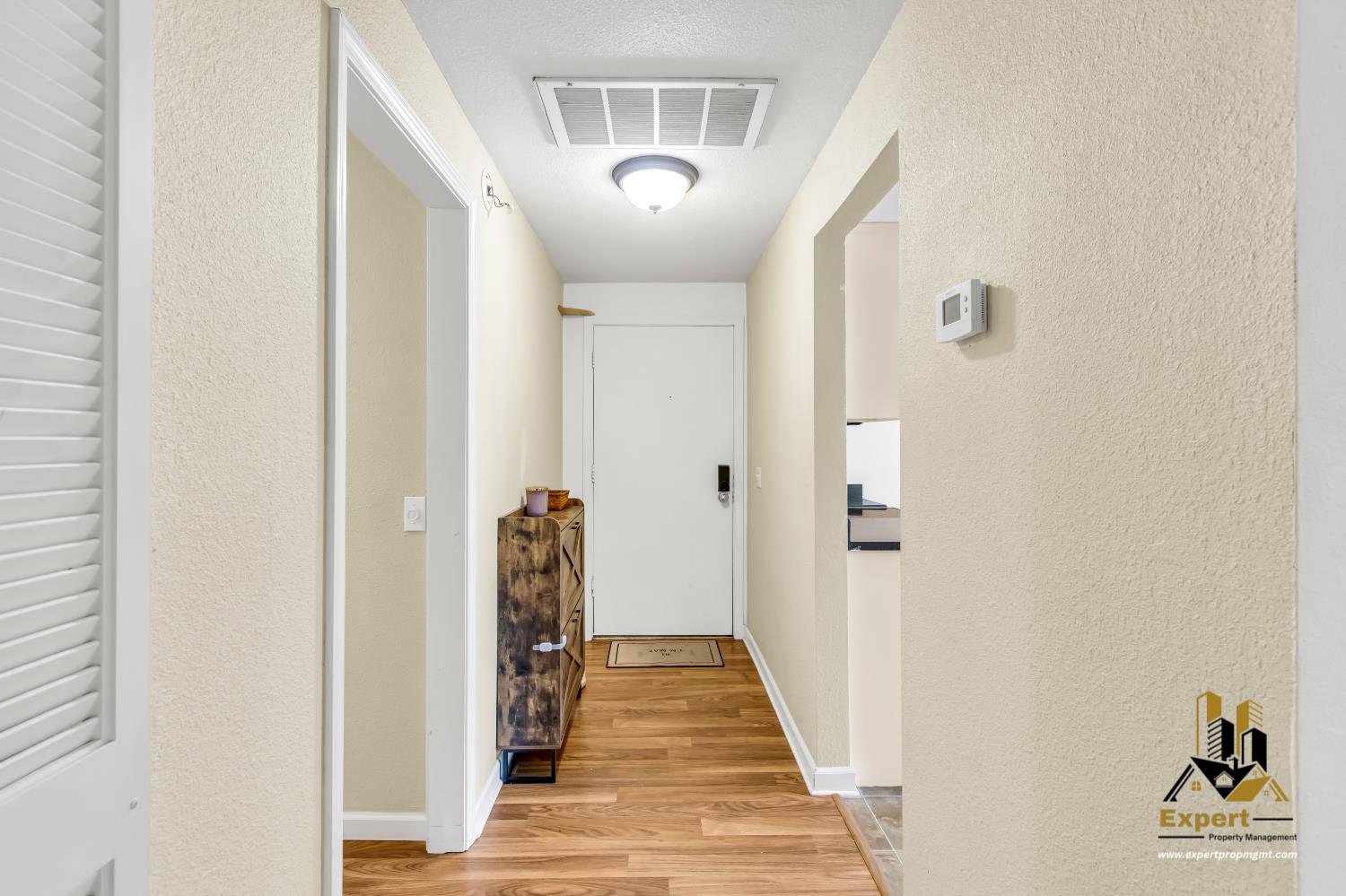 903 Fulton Avenue, Unit 406 Sacramento, CA 95825 - Photo 6 of 23 a view of a hallway with wooden floor and staircase