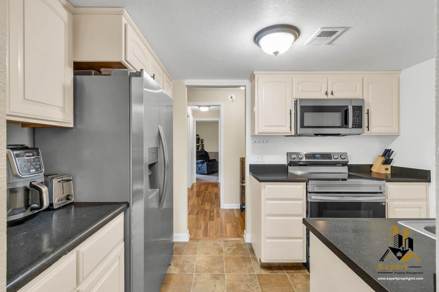 903 Fulton Avenue, Unit 406 Sacramento, CA 95825 - Photo 10 of 23 a kitchen with stainless steel appliances granite countertop a refrigerator stove and sink