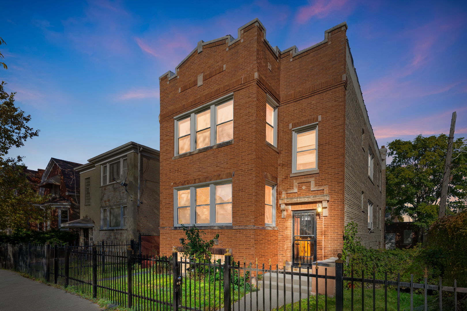4016 West Crystal Street Chicago, IL 60651 - Photo 1 of 17 a view of a brick house with many windows next to a yard