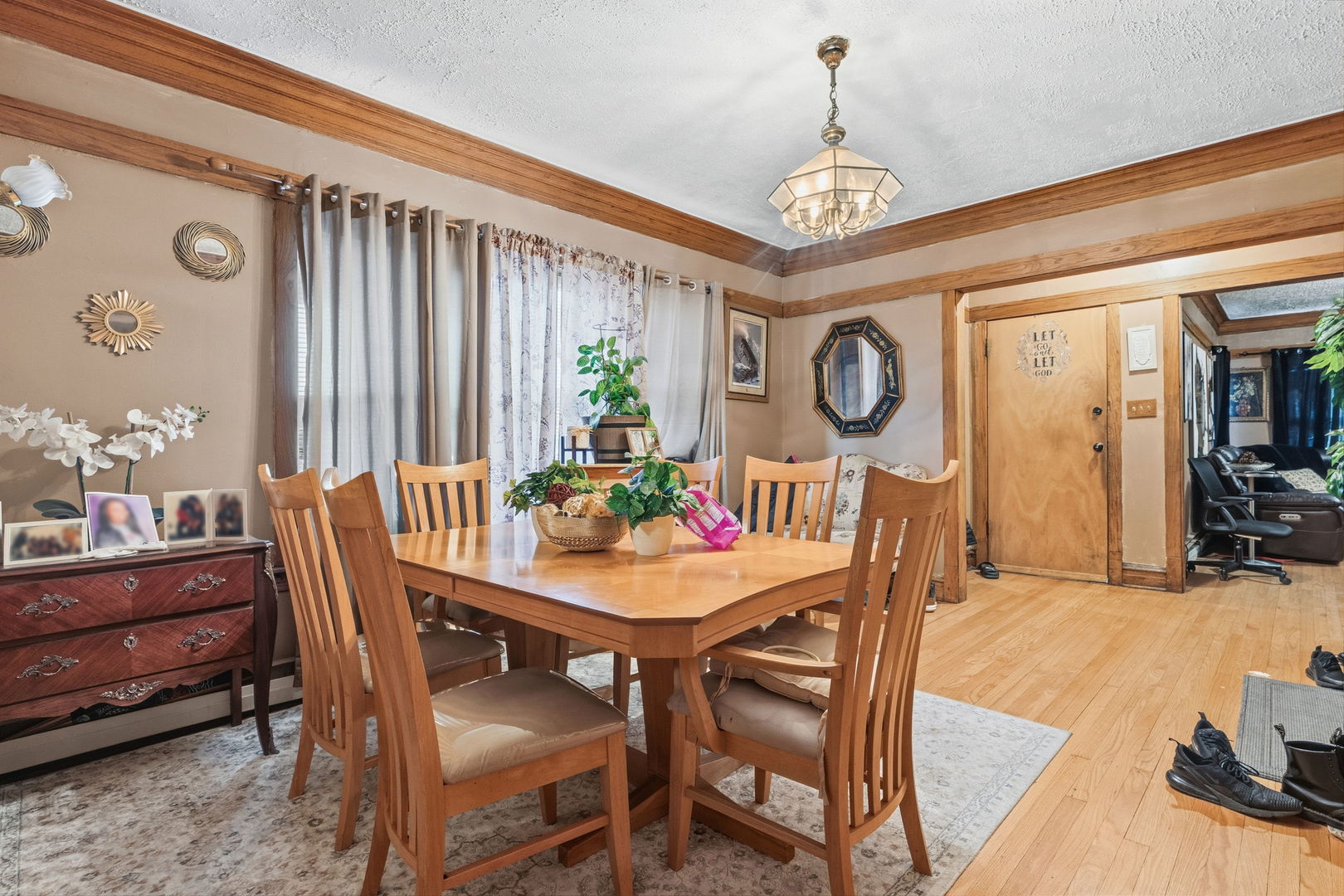 4016 West Crystal Street Chicago, IL 60651 - Photo 6 of 17 a dining room with furniture a chandelier and wooden floor