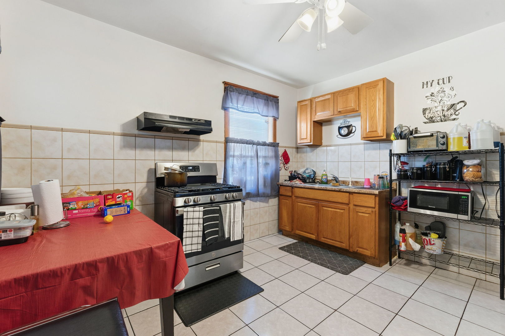 4016 West Crystal Street Chicago, IL 60651 - Photo 8 of 17 a kitchen with stainless steel appliances granite countertop a stove a sink and a refrigerator