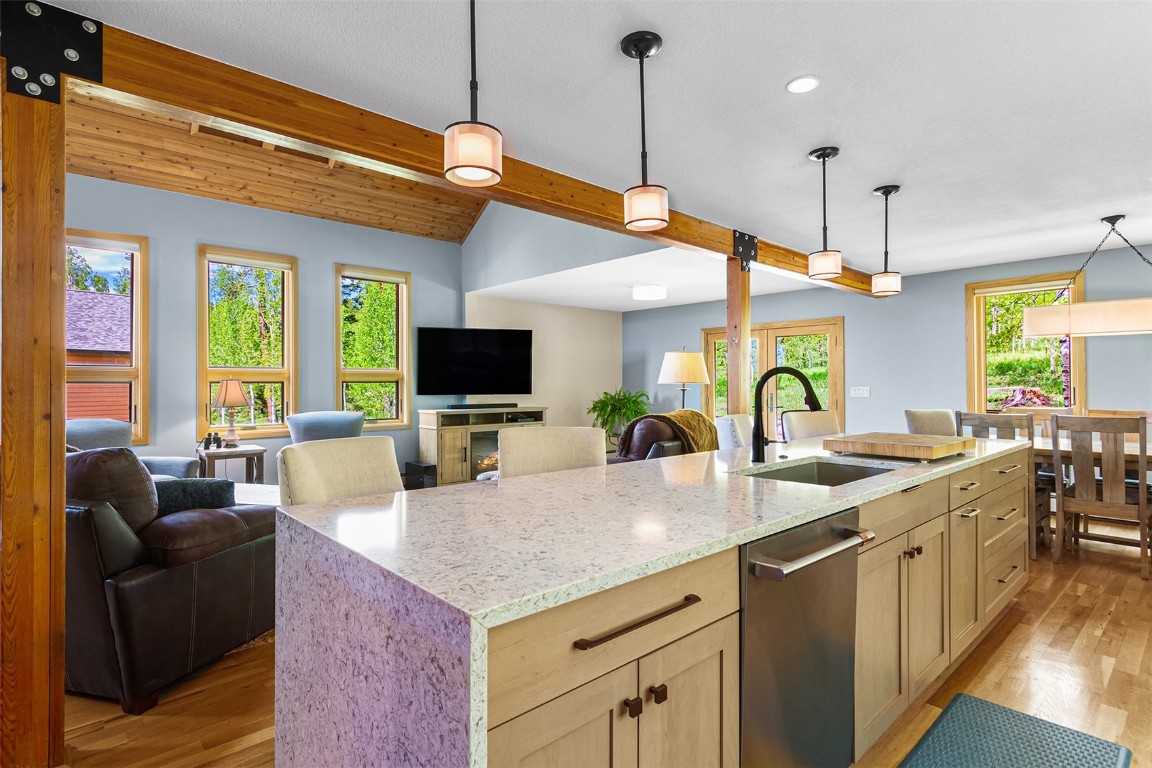 87 Spring Beauty Drive Silverthorne, CO 80498 - Photo 13 of 36 a view of a kitchen with kitchen island a window a sink and living room view