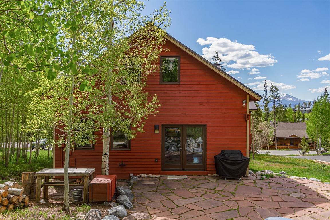 87 Spring Beauty Drive Silverthorne, CO 80498 - Photo 18 of 36 a view of backyard with table and chairs and a large tree