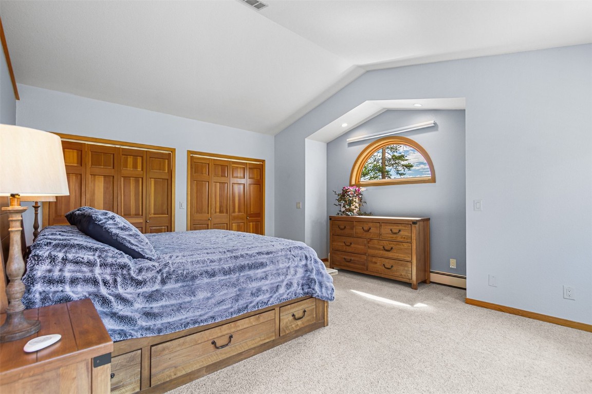 87 Spring Beauty Drive Silverthorne, CO 80498 - Photo 20 of 36 a bedroom with a bed and a dresser