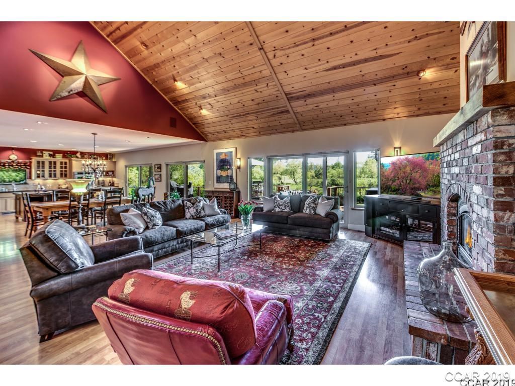 1331 Wingdam Road Murphys, CA 95247 - Photo 1 of 1 a living room with furniture a fireplace and wooden floor