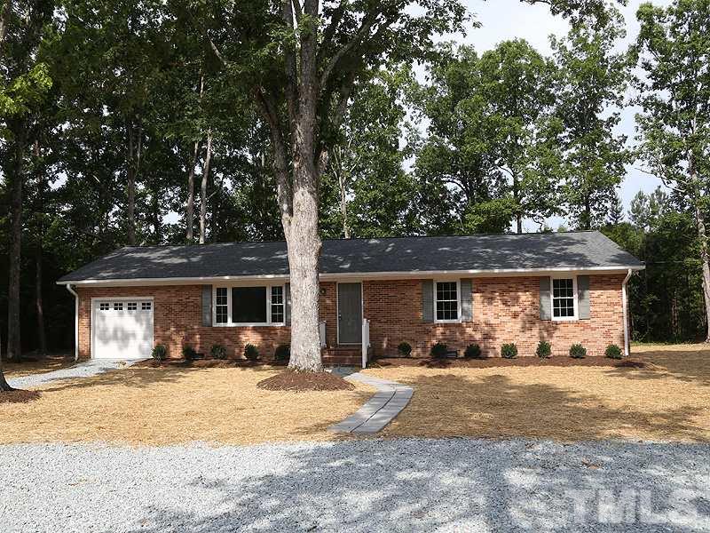 217 Chambers Road Rougemont, NC 27572 - Photo 1 of 19 a front view of house with yard and trees in the background