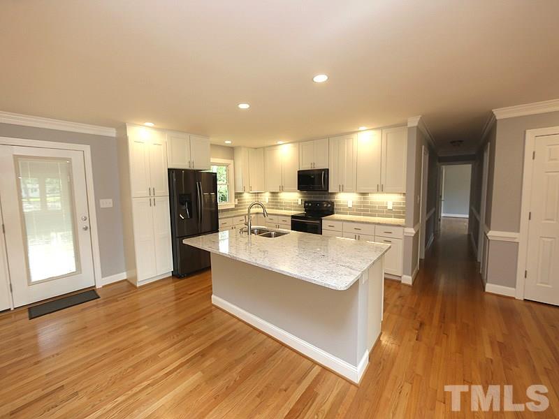 217 Chambers Road Rougemont, NC 27572 - Photo 3 of 19 a large kitchen with stainless steel appliances kitchen island a large counter top and a refrigerator