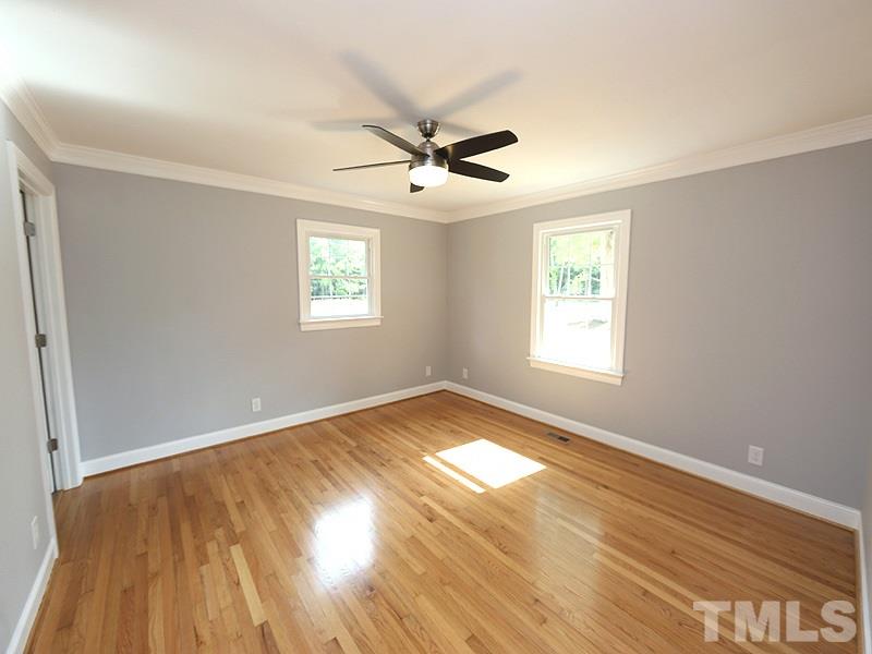 217 Chambers Road Rougemont, NC 27572 - Photo 8 of 19 an empty room with wooden floor ceiling fan and windows