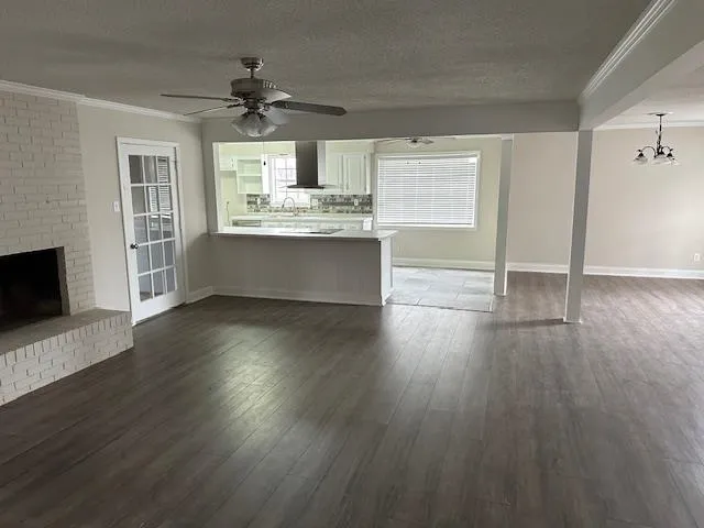 a large kitchen with hardwood floor a sink stainless steel appliances and cabinets