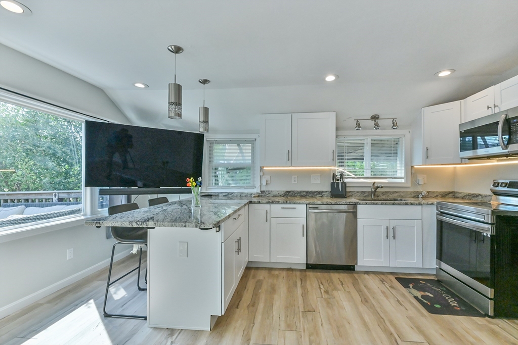 27 Lakeview Road Webster, MA 01570 - Photo 17 of 26 a kitchen with a sink stove and microwave