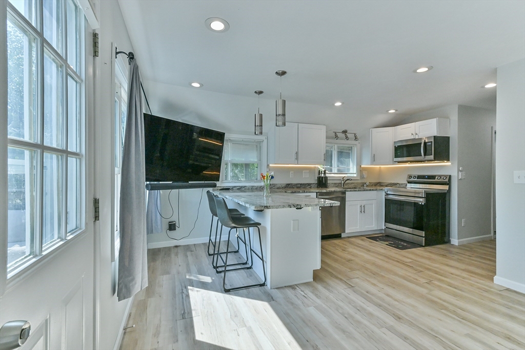 27 Lakeview Road Webster, MA 01570 - Photo 18 of 26 a kitchen with microwave a sink and cabinets