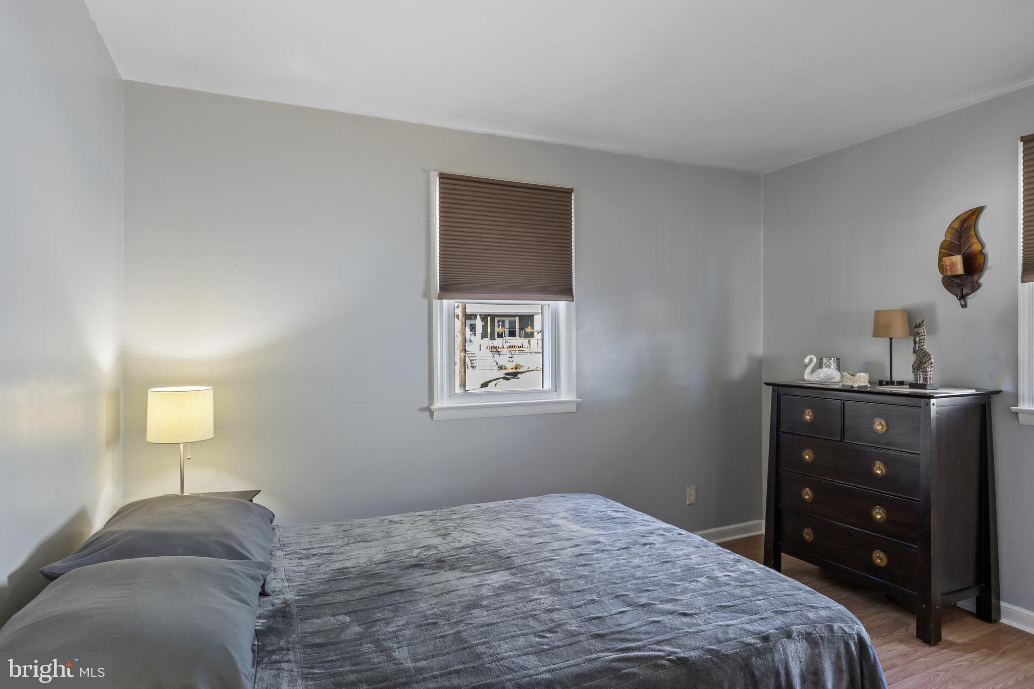 327 South Coles Avenue Maple Shade, NJ 08052 - Photo 13 of 22 a bedroom with a bed and a lamp on dresser