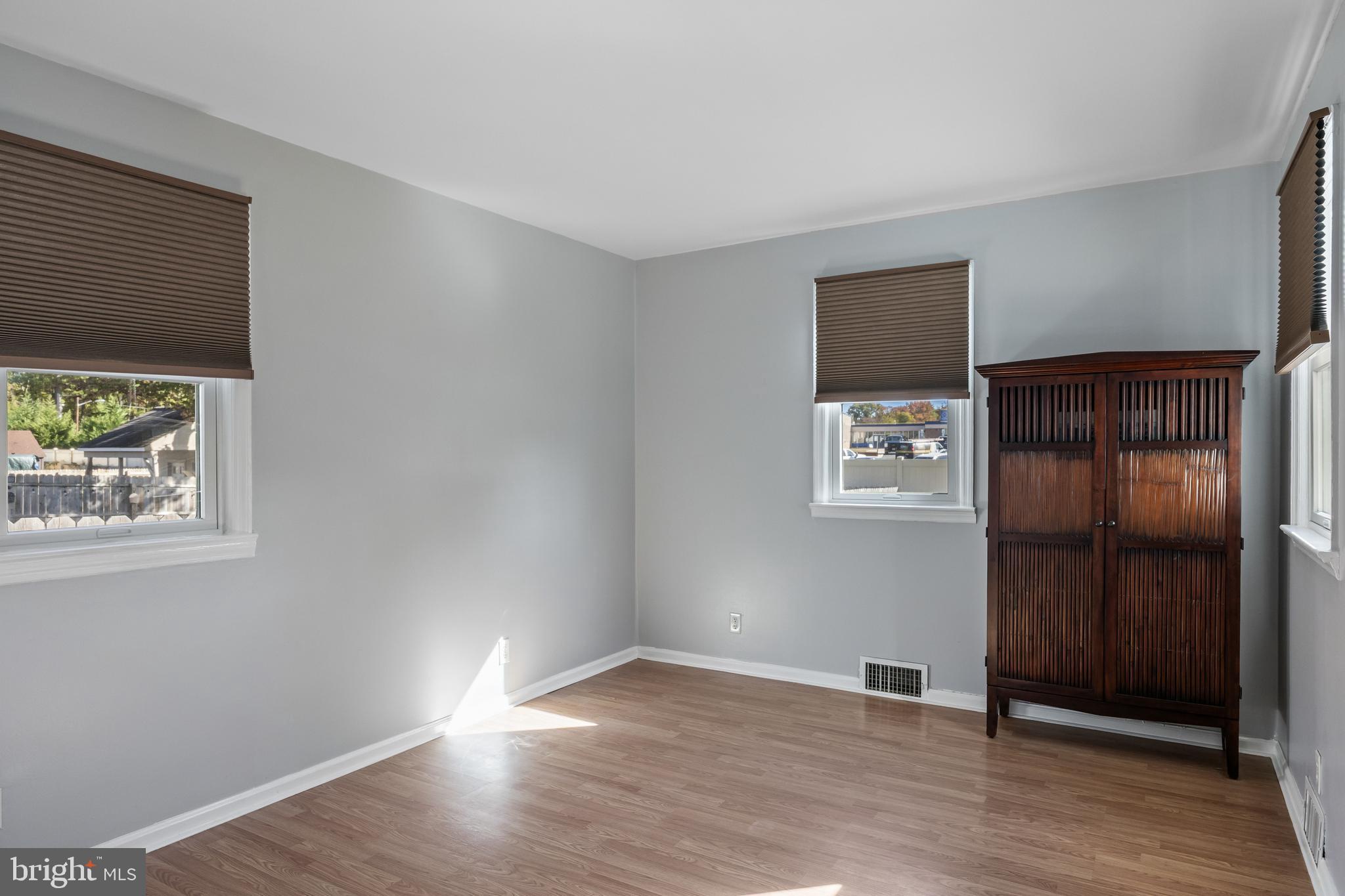 327 South Coles Avenue Maple Shade, NJ 08052 - Photo 16 of 22 a view of an empty room with wooden floor and a window