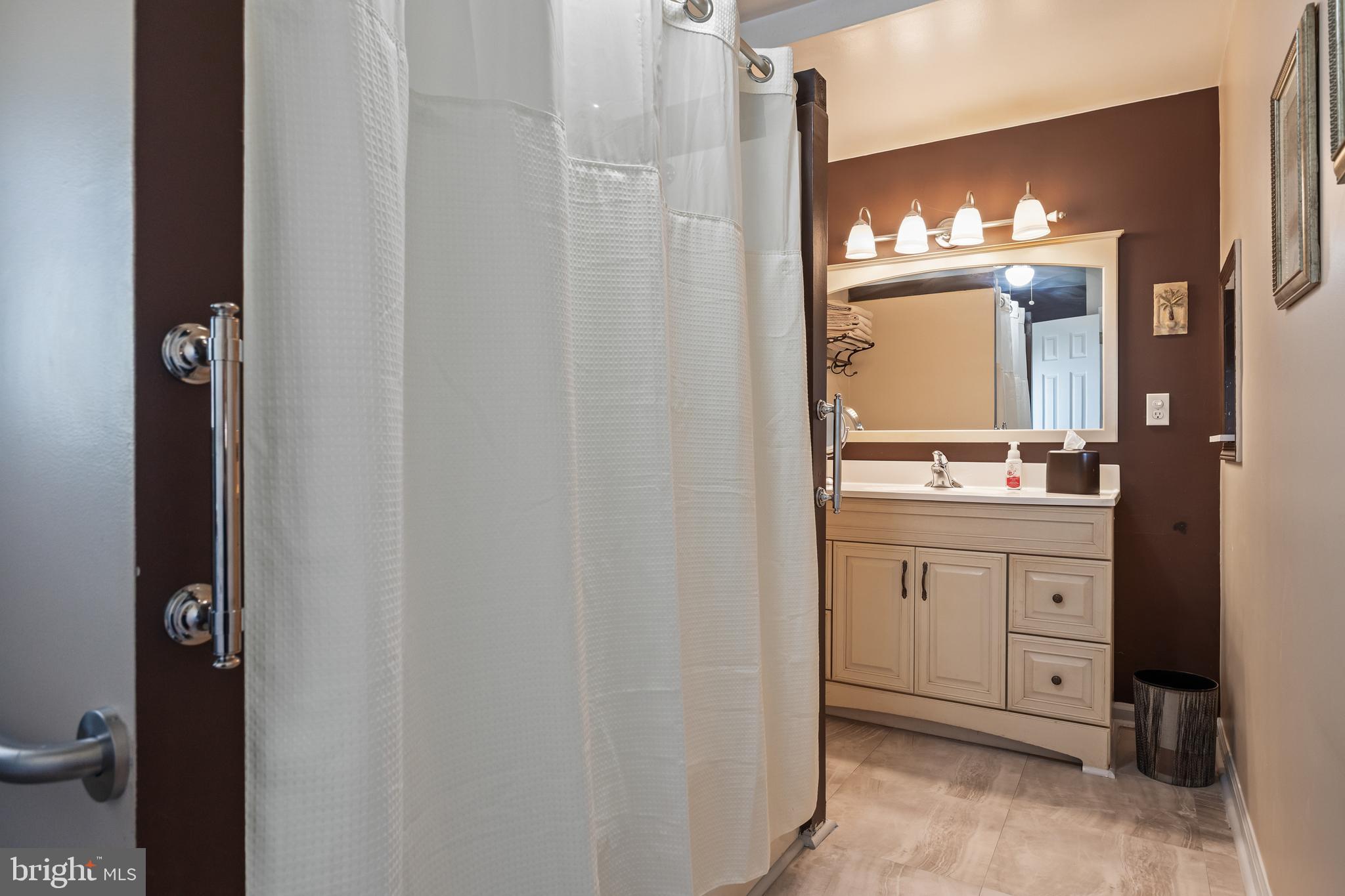 327 South Coles Avenue Maple Shade, NJ 08052 - Photo 20 of 22 a bathroom with a sink and a mirror