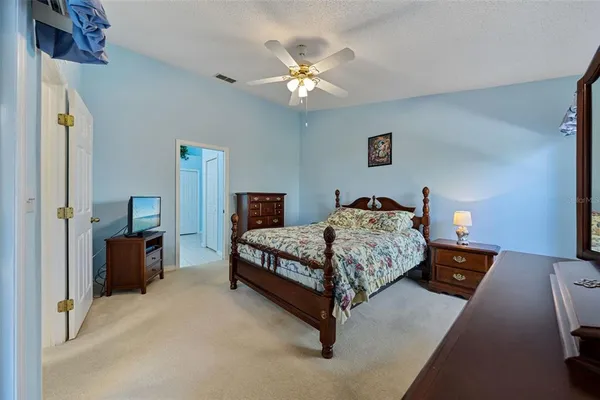 a bedroom with a bed and a chandelier