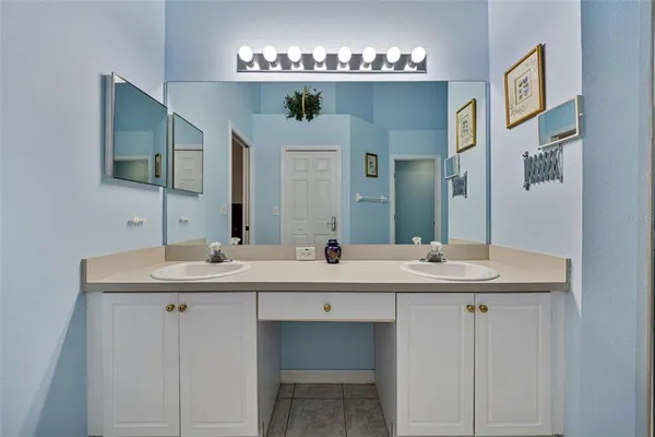 a bathroom with double sink and a mirror