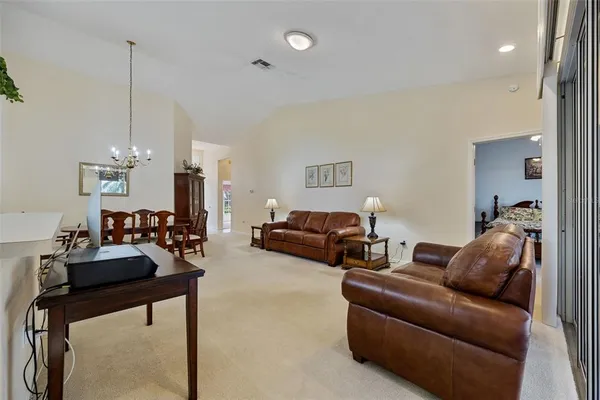 a living room with furniture and a chandelier