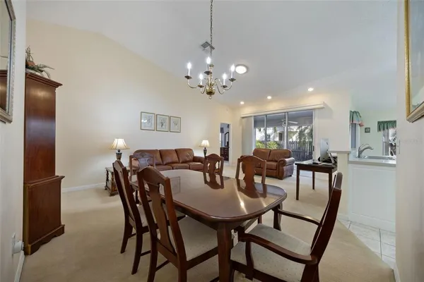 a view of a dining room with furniture and a chandelier