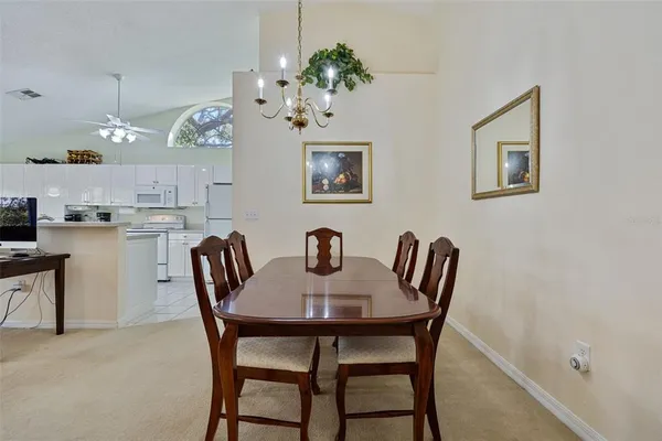 a view of a dining room with furniture and chandelier