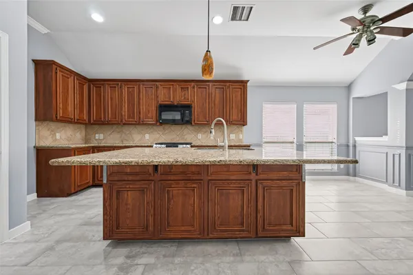 a kitchen with a sink a stove and cabinets