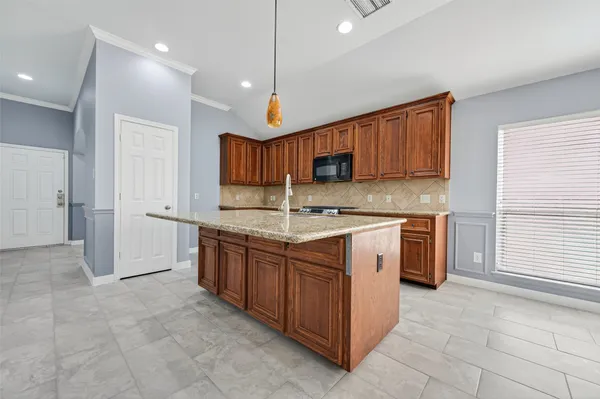 a kitchen with stainless steel appliances granite countertop a stove sink and cabinets