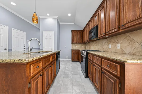 a kitchen with stainless steel appliances granite countertop a sink and cabinets
