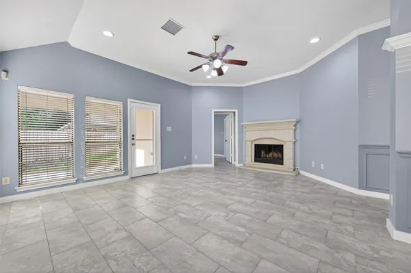 a view of an empty room with a fireplace and a window