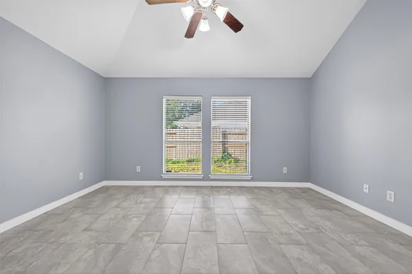 an empty room with a empty space and windows