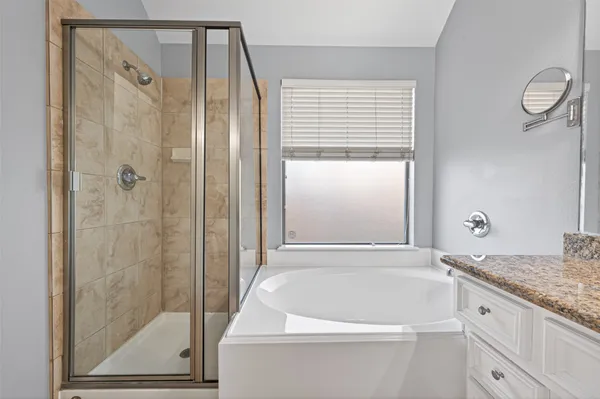 a bathroom with a bathtub and a shower