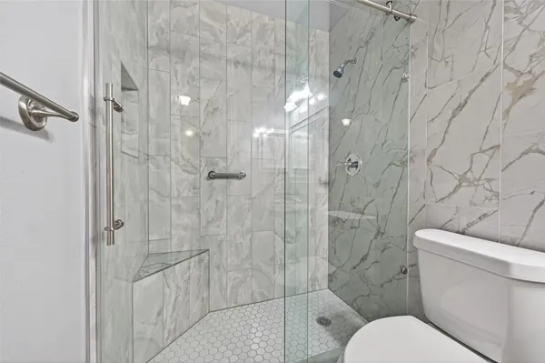 a bathroom with a toilet and shower