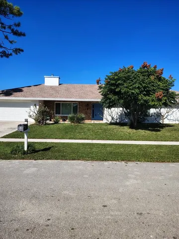 a view of a house next to a yard