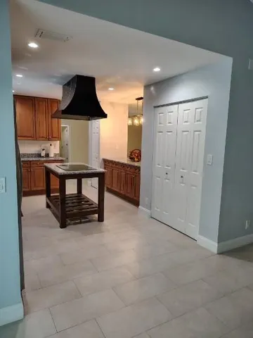 a view of kitchen with furniture and refrigerator