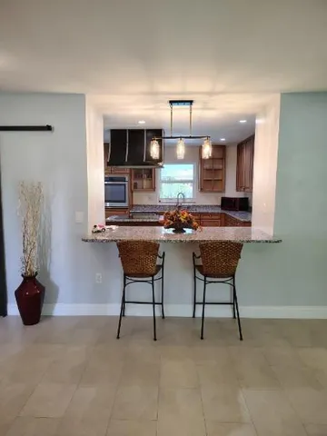 a room with furniture a chandelier and a window