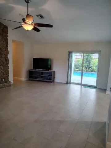 a view of livingroom with furniture wooden floor and a ceiling fan