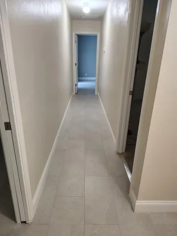 a view of a hallway to rooms