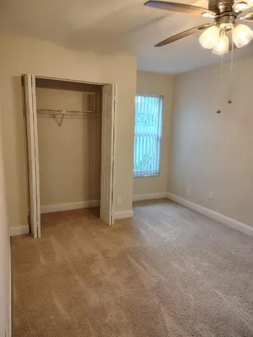 an empty room with windows and closet
